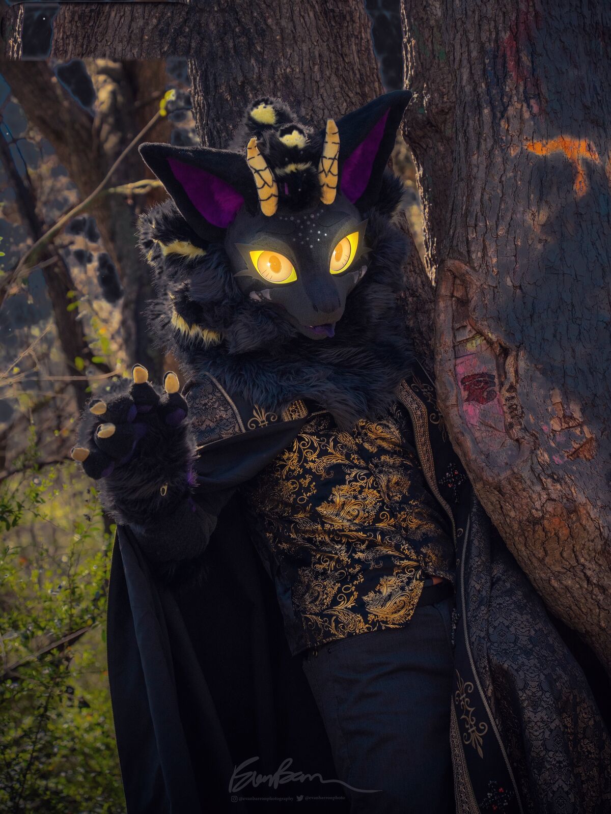 Nyxandriel beside a tree at dusk, raising a paw
